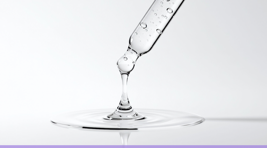     Clear skincare serum dripping from a glass dropper for a Two Sisters Ko blog about PDRN skincare